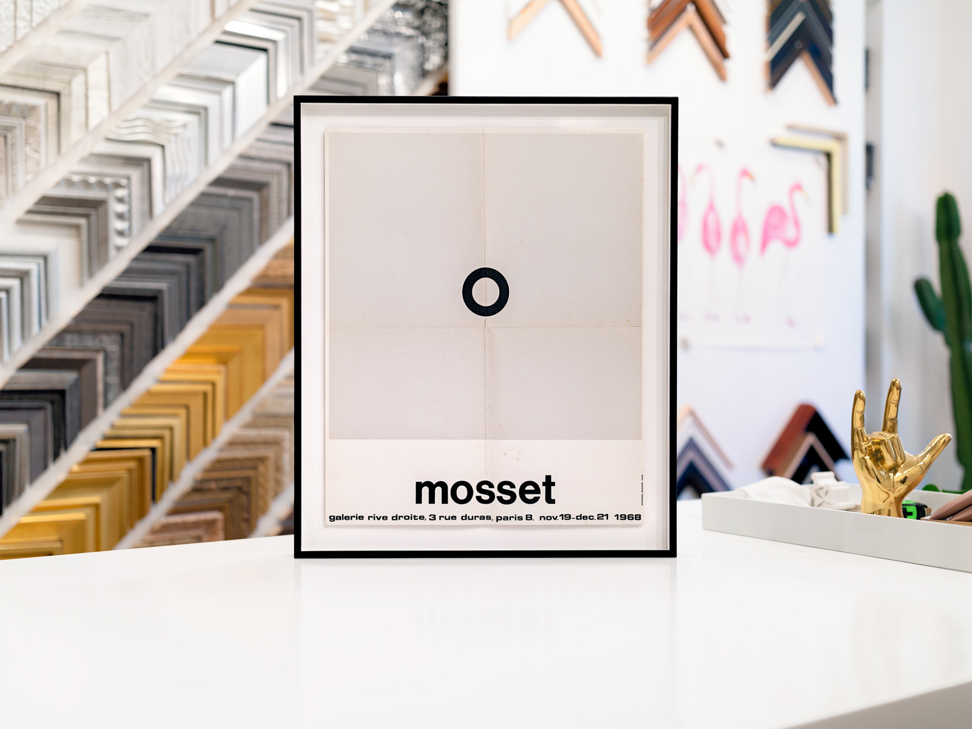 Vintage, creased and discolored, Mosset poster floating on a clean, bright white mat and framed with a thin, welded aluminum black frame.