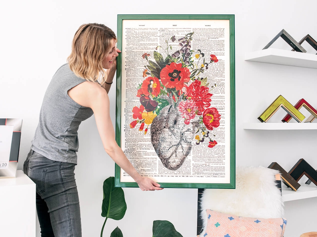 A vintage inspired botanical poster print is framed in a light and dark green striped semi-gloss frame.